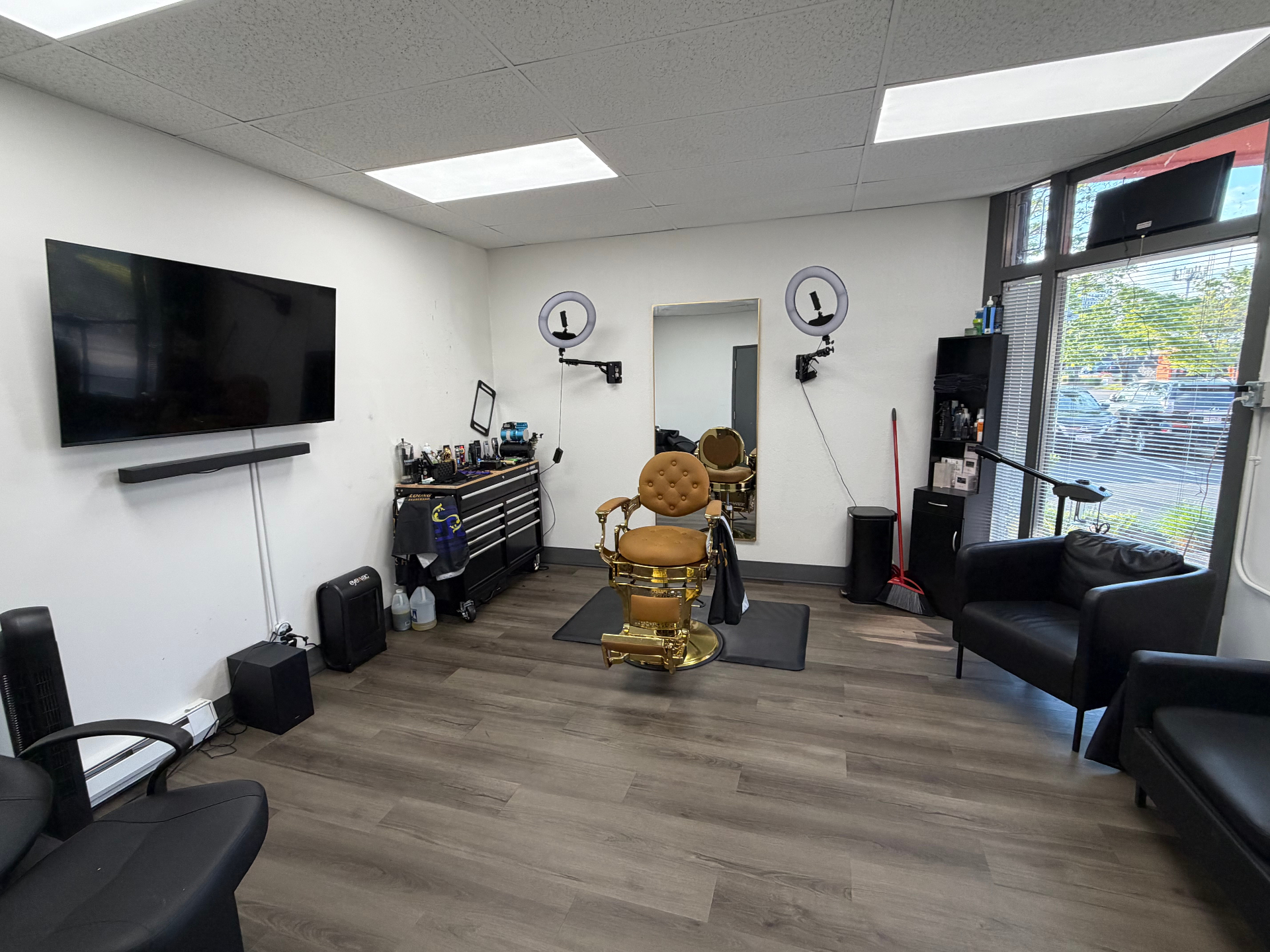 Inside The Gentlemen's Lounge Barbershop — vintage chairs and dark wood interior